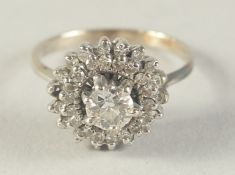 AN 18CT WHITE GOLD AND DIAMOND CLUSTER RING.