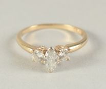 A 14CT GOLD AND DIAMOND THREE STONE RING with central marquis cut diamond.