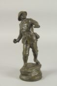 A BRONZE GRENADIER, WORLD WAR ONE, throwing a grenade, standing on a circular base. 26cm high.