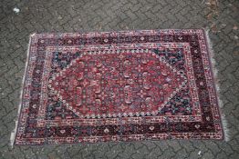A GOOD PERSIAN CARPET red ground with all over stylised decoraction. 8ft 8ins x 5ft 4ins.