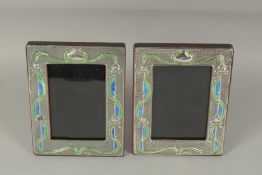 A PAIR OF SILVER AND ENAMEL PHOTOGRAPH FRAMES. 7.25ins x 5.5ins.
