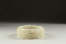 A CHINESE WHITE JADE BANGLE. 3ins diameter.