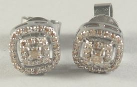 A PAIR OF ART DECO STYLE DIAMOND EAR STUDS.