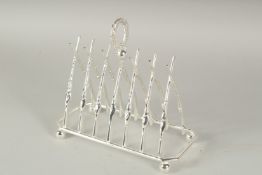 A CHRISTOPHER DRESSER STYLE SILVER PLATED CROSSED GUNS TOAST RACK.