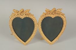 A GILT BRONZE DOUBLE HEART PHOTO FRAME. 7.5ins high.
