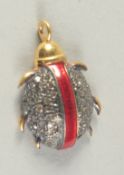 A SMALL GOLD RUBY AND DIAMOND CHARM in the form of a bug.