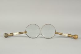 A PAIR OF BRASS AND MOTHER OF PEARL MAGNIFYING GLASSES.