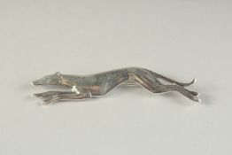 A SILVER BROOCH MODELLED AS A RUNNING GREYHOUND.