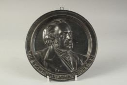 A BRONZE CIRCULAR PLAQUE 