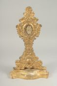 A 17TH CENTURY GILDED WOOD RELIQUARY Papal seal, 1016 on reverse. 12ins high.