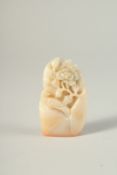 A CHINESE CARVED HARDSTONE SEAL, a bird and a flower. 2.75ins long.