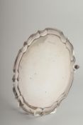 A PIE CRUST SILVER SALVER on four knurled feet. 10ins diameter. Birmingham 1967, weight: 15ozs.