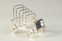 A SILVER PLATED TOAST RACK modelled as an old car. 6.5ins long.