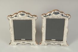 A PAIR OF MODERN HALLMARKED SILVER PHOTOGRAPH FRAMES, in the Victorian style. Image size: 5ins x 3.