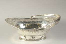 A LARGE GEORGE III SILVER OVAL CAKE BASKET with swing handles engraved with garlands. 13ins long.