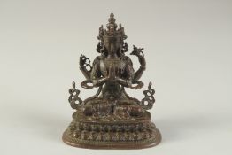 A SMALL BRONZE TIBETAN SEATED MULTI ARM BUDDHA. 3.75ins high.