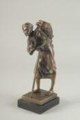 A BRONZE FIGURE OF AN ARAB WATER SELLER on a square marble base. 9ins high.