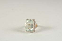 A 14CT GOLD AND DIAMOND RING set with a large emerald cut AQUAMARINE.
