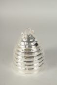 A SILVER PLATED HONEY POT AND COVER.