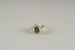 A GOOD YELLOW GOLD EMERALD AND DIAMOND RING.