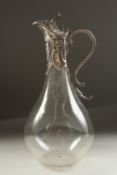 A PLAIN GLASS CLARET JUG with silver mounts and handle. London 1933.