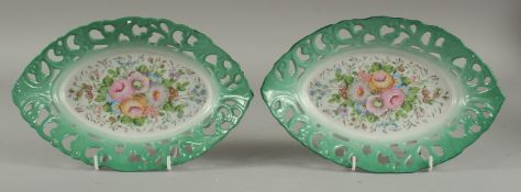 A PAIR OF SEVRES DESIGN PORCELAIN OVAL PIERCED FLORAL DISHES. 10ins diameter.