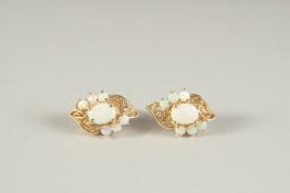 A PAIR OF 18CR GOLD AND OPAL CLUSTER EAR CLIPS.