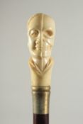 A CARVED BONE HANDLE WALKING STICK 