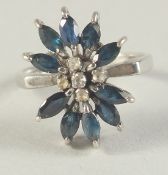 AN 18CT GOLD DIAMOND AND SAPPHIRE RING.