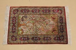 A SMALL PERSIAN PART SILK RUG cream ground with red ground border, 