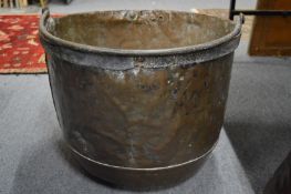 A large copper and wrought iron pot.