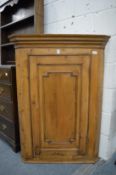 A 19th century pine hanging corner cupboard.