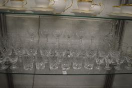A quantity of cut glass drinking glasses and a decanter.