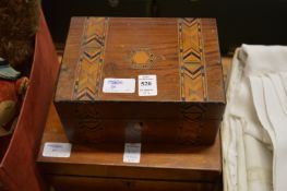A jewellery box with decorative necklaces together with a writing slope.