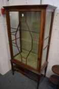 A mahogany standing display cabinet.