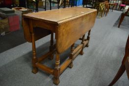A mahogany drop-leaf gateleg coffee table.