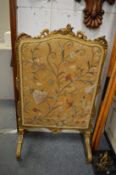A gilt framed fire screen.