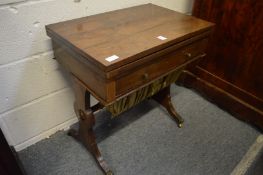 A 19th century rosewood combination table with folding rectangular top, single frieze drawer and