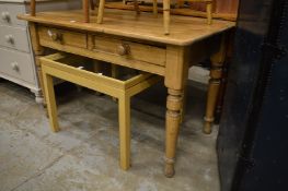 A pine two drawer side table.