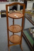 An oak three-tier folding cake stand.