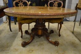 A Victorian inlaid walnut oval tilt-top breakfast table.