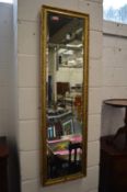 A gilt framed dressing mirror.