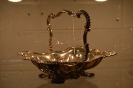 An embossed white metal basket with swing handle.