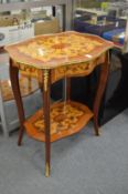 A French style decoratively inlaid two-tier single drawer occasional table.