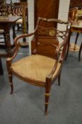 A good pair of Regency design rosewood grained and parcel gilded open armchairs with cane work