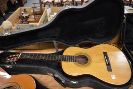 A cased classical guitar.