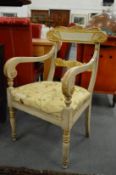 A pair of decorative carved, painted and parcel gilded open armchairs.
