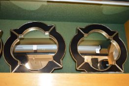 A set of four decorative mirrors with shaped frames.