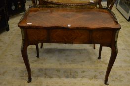 A 19th century rosewood Poudreuse style table, of shaped outline with brass galleried back, three