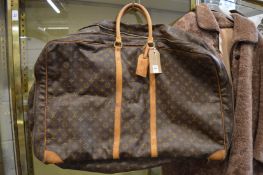 A Louis Vuitton holdall.
